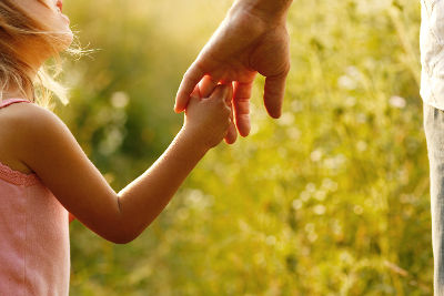 a parent holds the hand of a small child Individual support